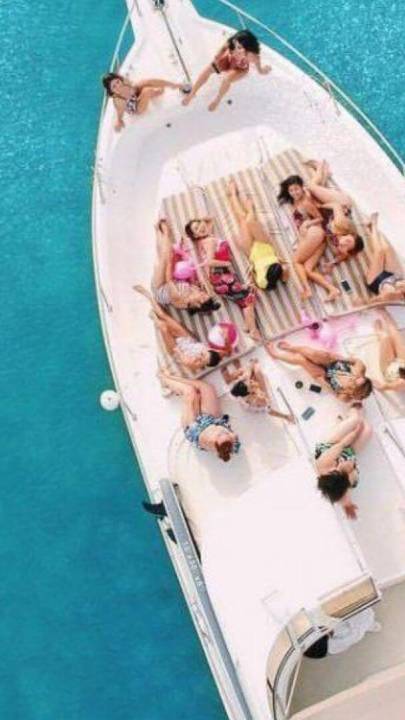 Private yacht in the sea with women on top posing