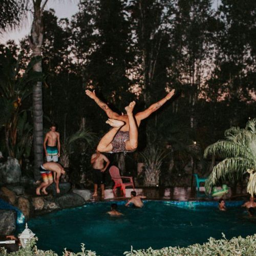 Guy jumping into a pool