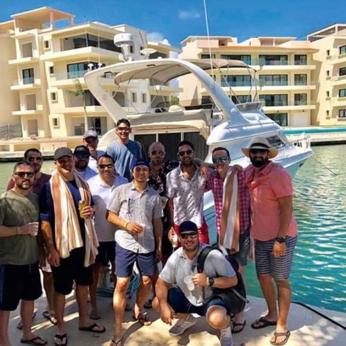 Group of guys in front of a yacht