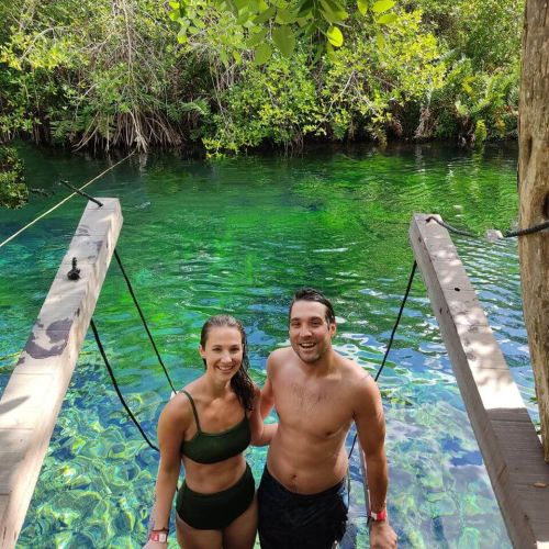 2 people standing in a wood structure inside the lagoon