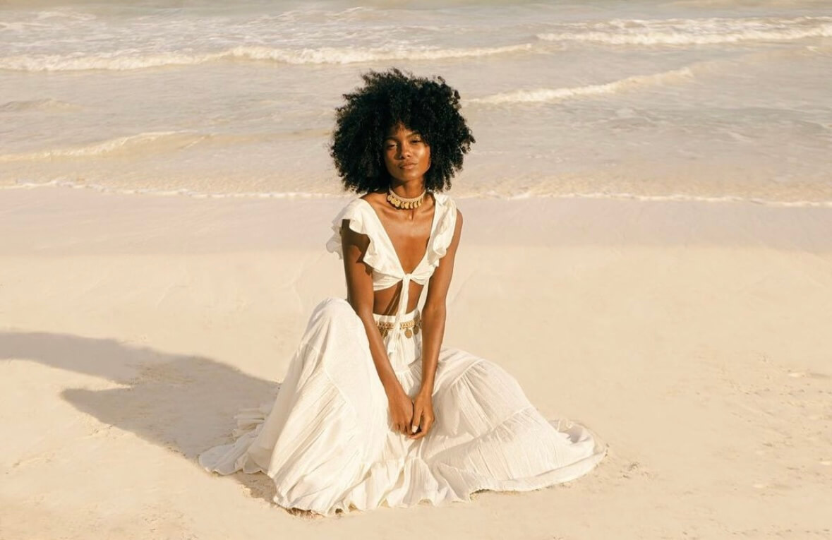 Girl modeling a white skirt and top set at the beach